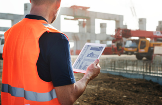 Bauarbeiter mit Tablet auf einer Baustelle